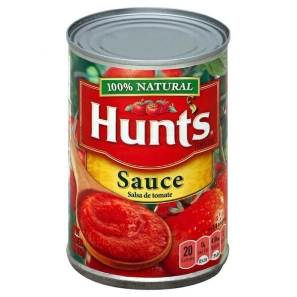 A can of sauce with tomatoes on top.