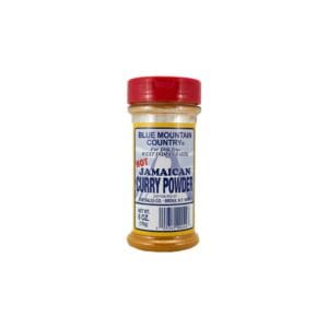 A jar of curry powder on top of a white table.